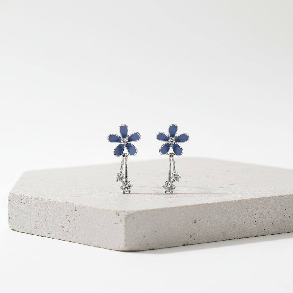 Blue flower earrings on grey stone podium