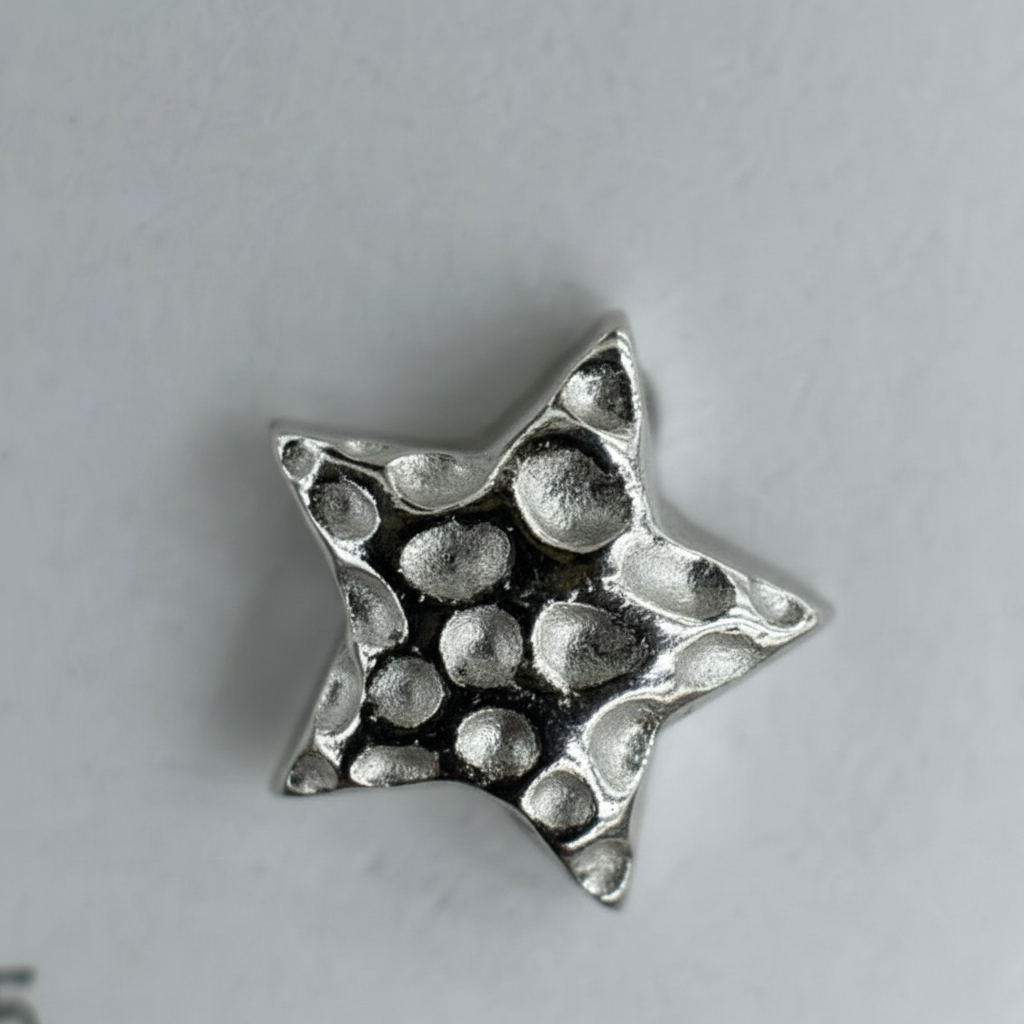 Macro close-up of silver star earring craftsmanship