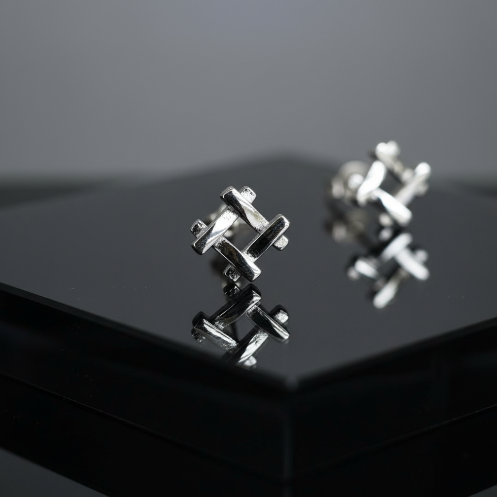 Silver 925 geometric earrings macro detail on black surface